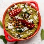 Coconut Coriander Chutney served in a red bowl with tempering on top
