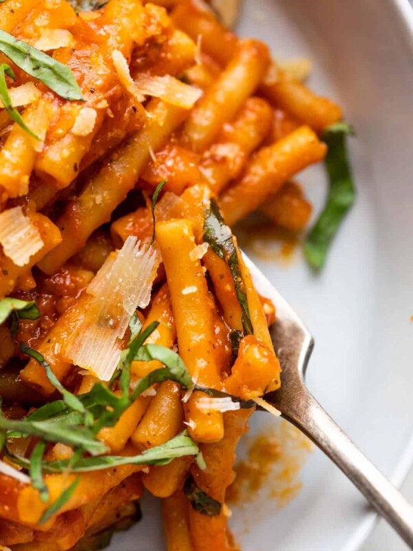 Closeup of instant pot pasta in red sauce being eaten with a fork