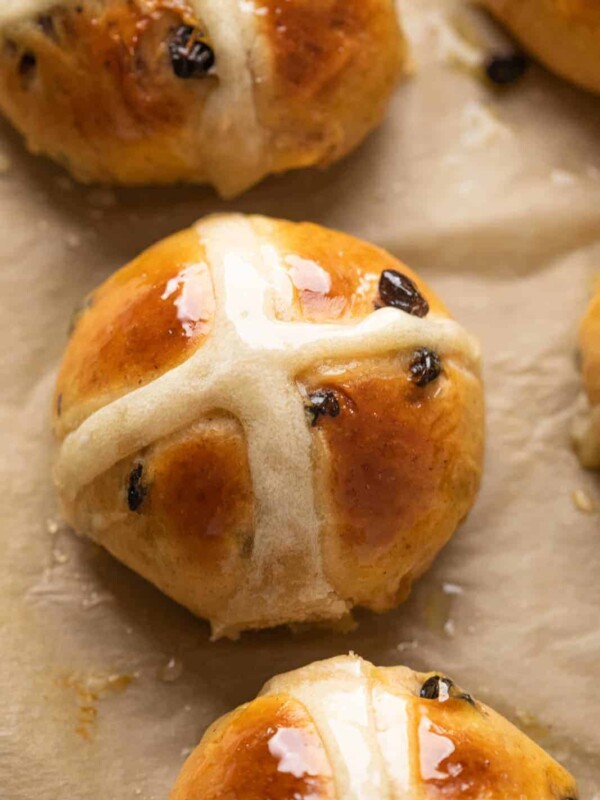 Closeup of one hot cross bun to show how beautifully glazed they are