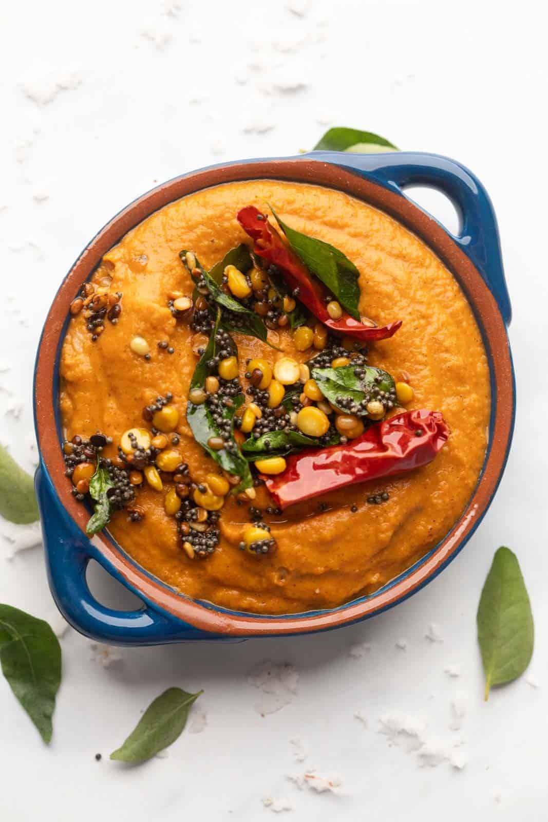 Tomato Chutney served in a blue bowl with tempering on top
