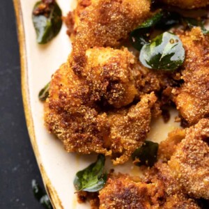 Closeup of prawn rava fry on a beige platter