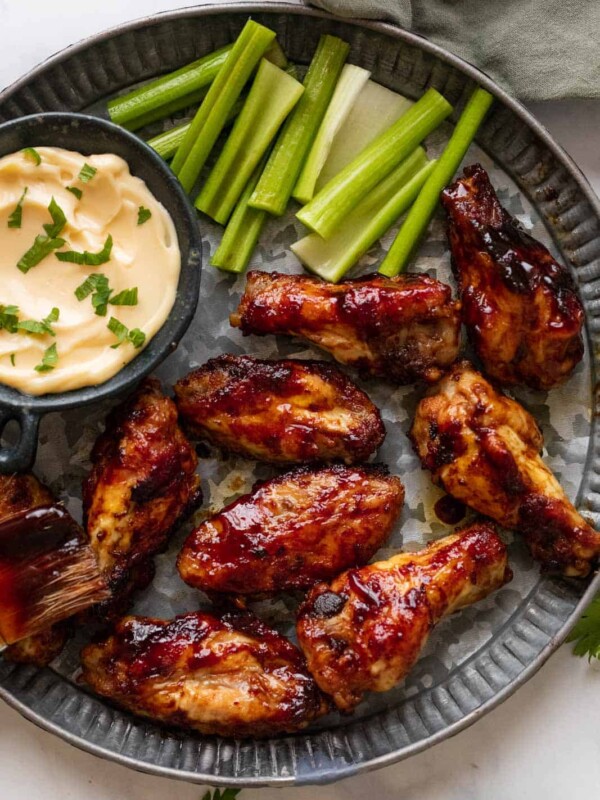 Spicy BBQ Chicken Wings on a hammered silver plate with aioli and celery on the side