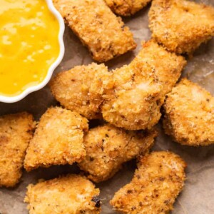 Chicken Nuggets served on a plate with a mango mustard dipping sauce