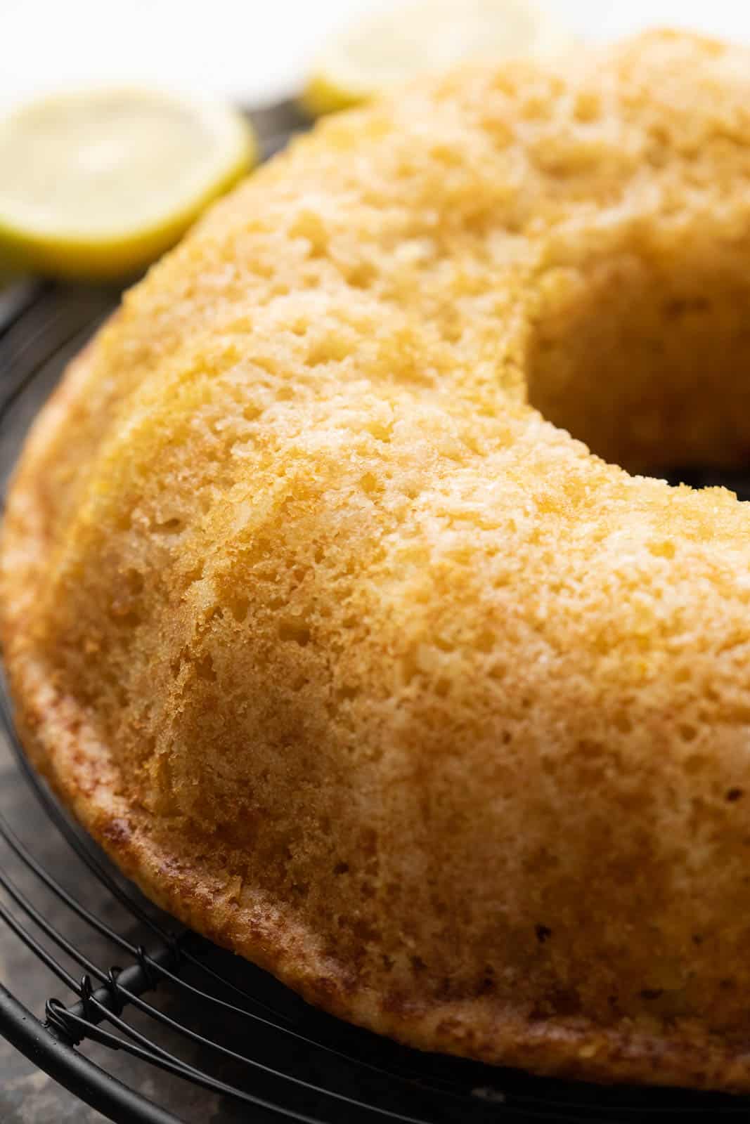 Closeup of the top of the eggless lemon cake being cooled on a rack