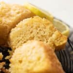 A slice of eggless lemon cake to show the light airy texture of the cake
