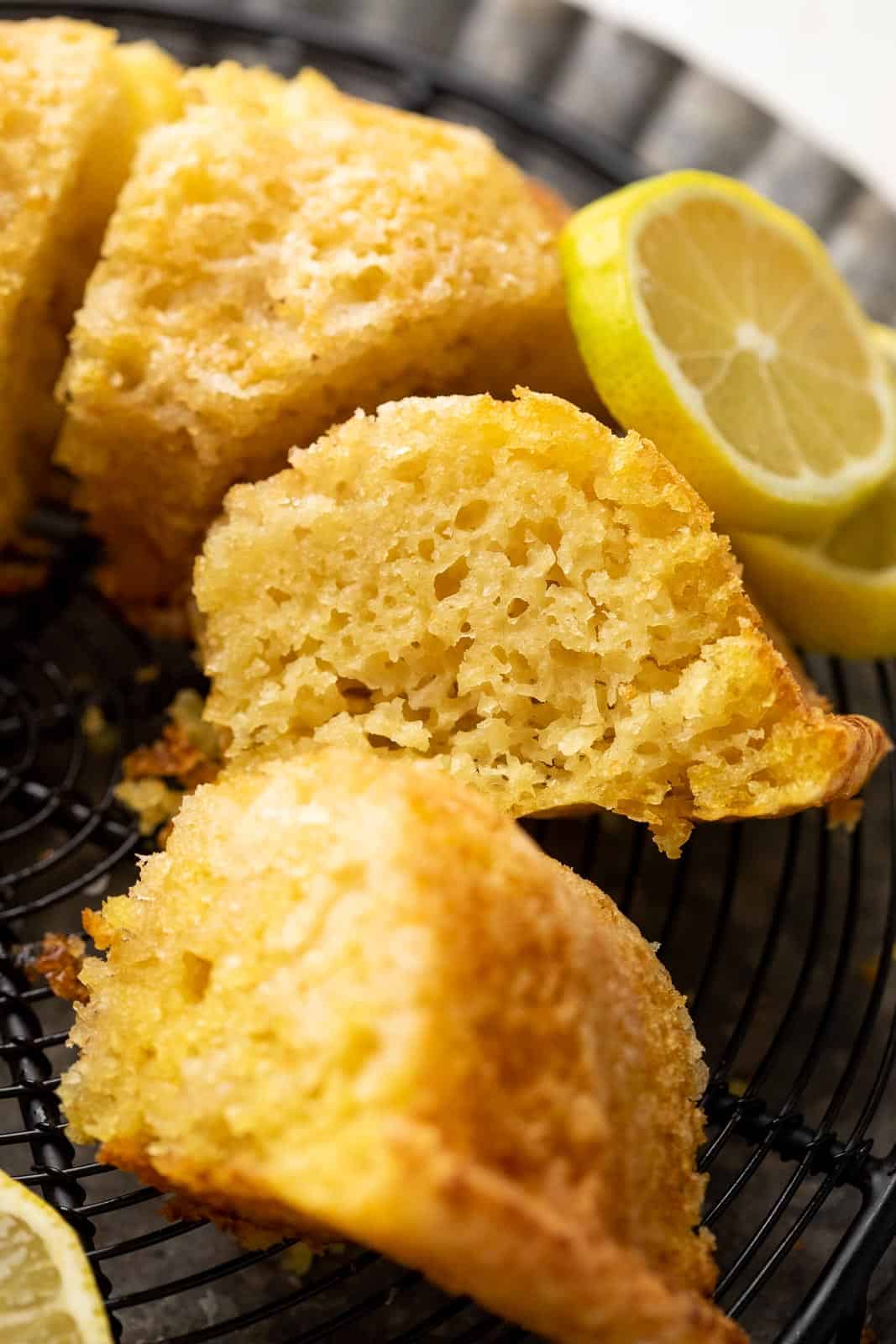 A slice of eggless lemon cake to show the light airy texture of the cake
