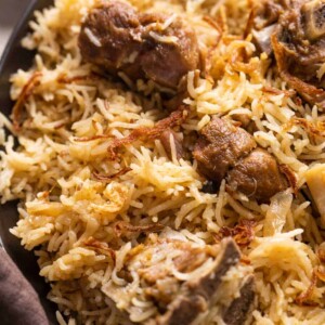 Closeup of yakhni pulao to show the texture of rice and mutton pieces