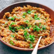 Baingan Bharta garnished with coriander and served in a red dish!