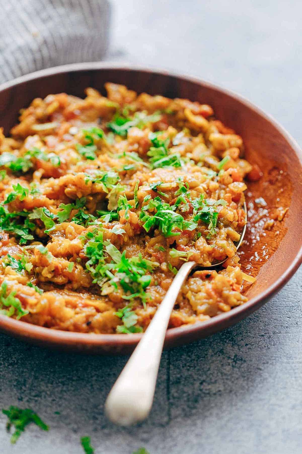 Baingan Bharta garnished with coriander and served in a red dish!