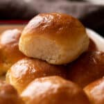 Single ladi pav stacked on top of other baked ladi pavs