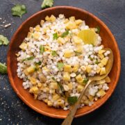 Sabudana khichdi served in a brown bowl with a spoon