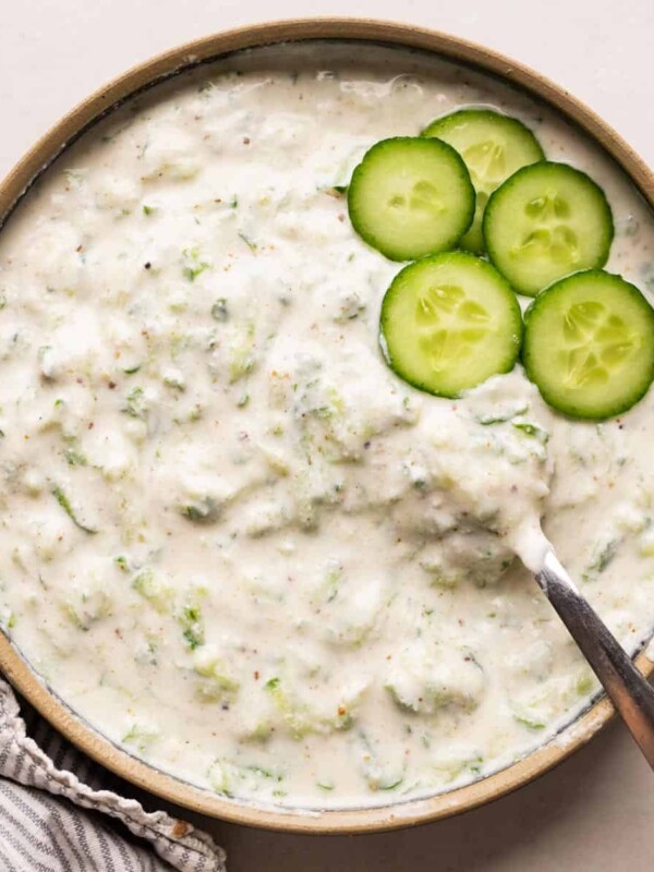 Cucumber Raita served in a bowl with sliced cucumber as garnish