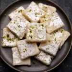 Coconut barfi served on a grey plate
