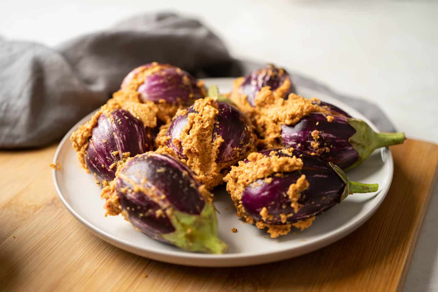 Picture of stuffed brinjals on a plate ready to be added to the curry
