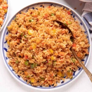 Picture of chilli garlic fried rice served on a white and blue plate
