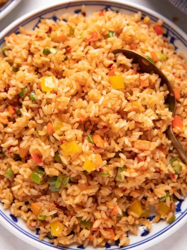 Picture of chilli garlic fried rice served on a white and blue plate