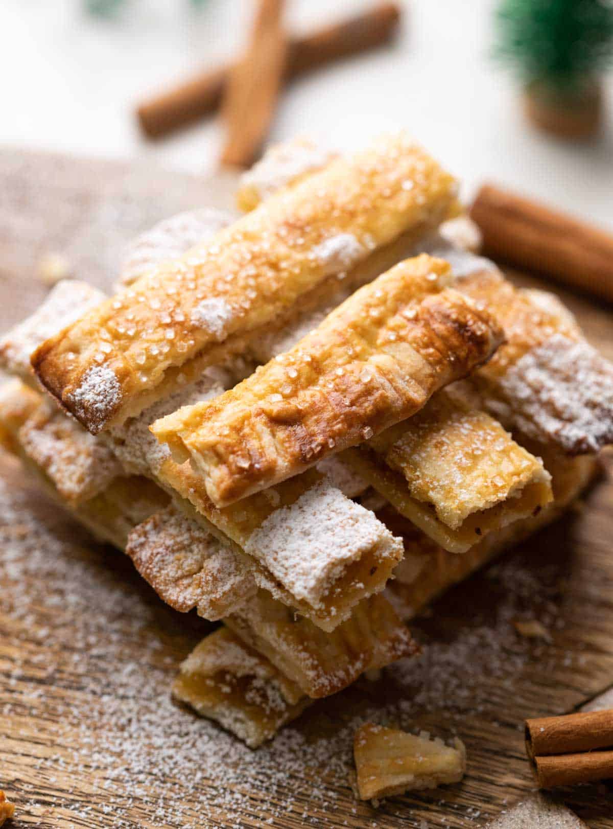 Apple Pie Chips stacked on a wooden board with salted caramel sauce.