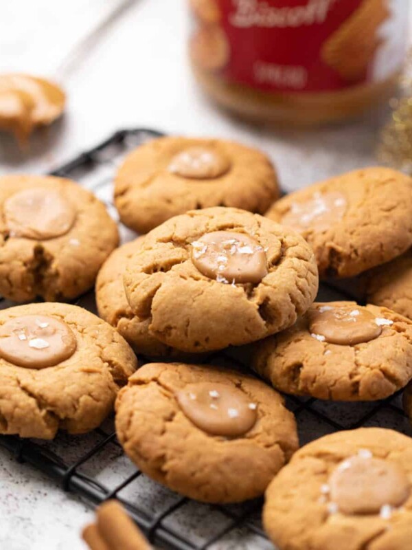 A shot of biscoff cookies stacked one one top of another on a black grill tray.