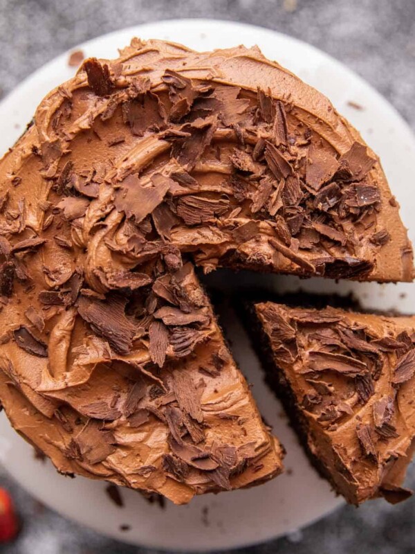 chocolate cake with chocolate buttercream on a white plate