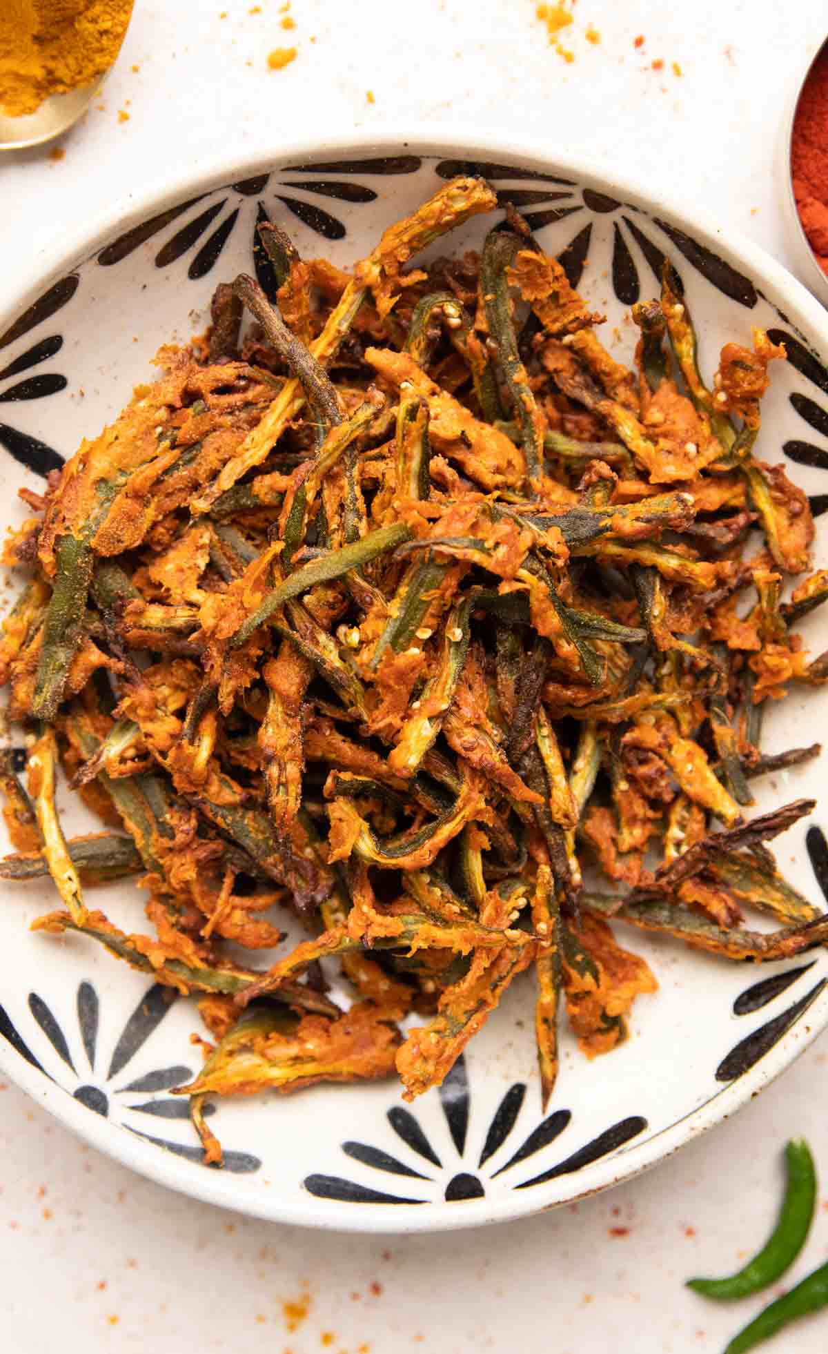 Air fried kurkuri bhindi in a white bowl