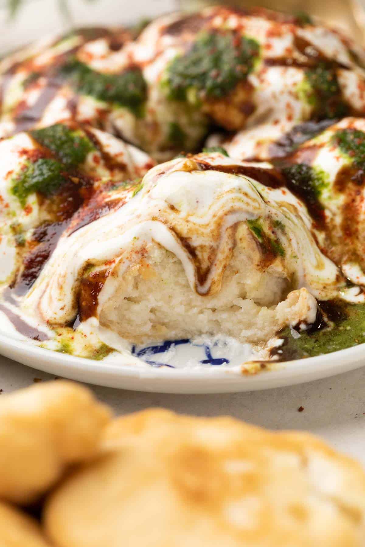 close up of a cut piece of dahi vada 