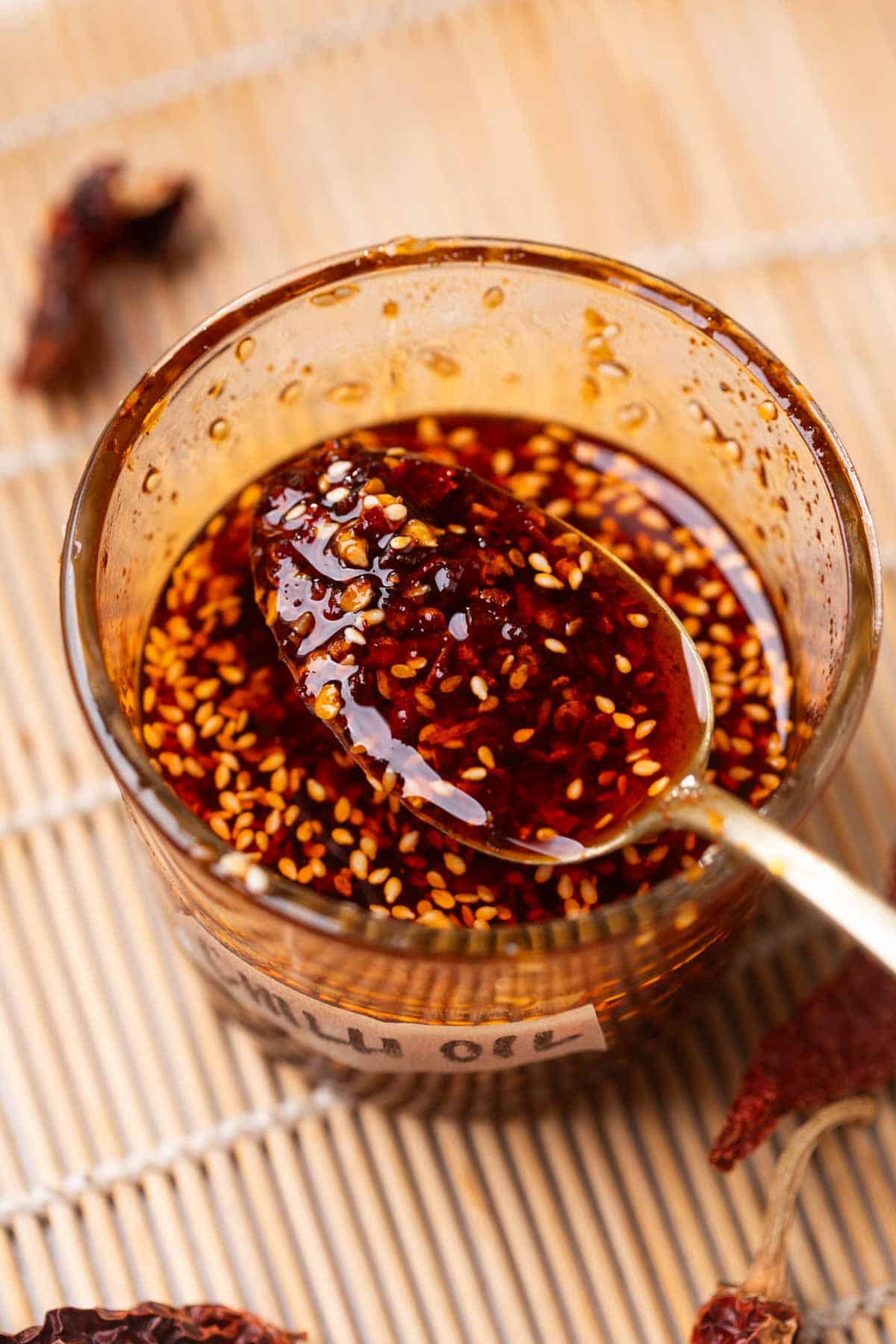homemade chilli scooped up in a spoon to show it's color and texture