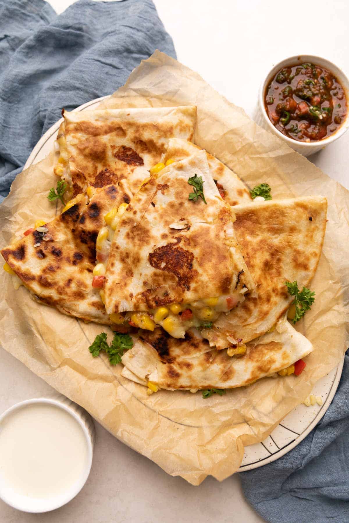 bell pepper corn and cheese quesadilla with crispy bits of cheese with a side of tomato salsa