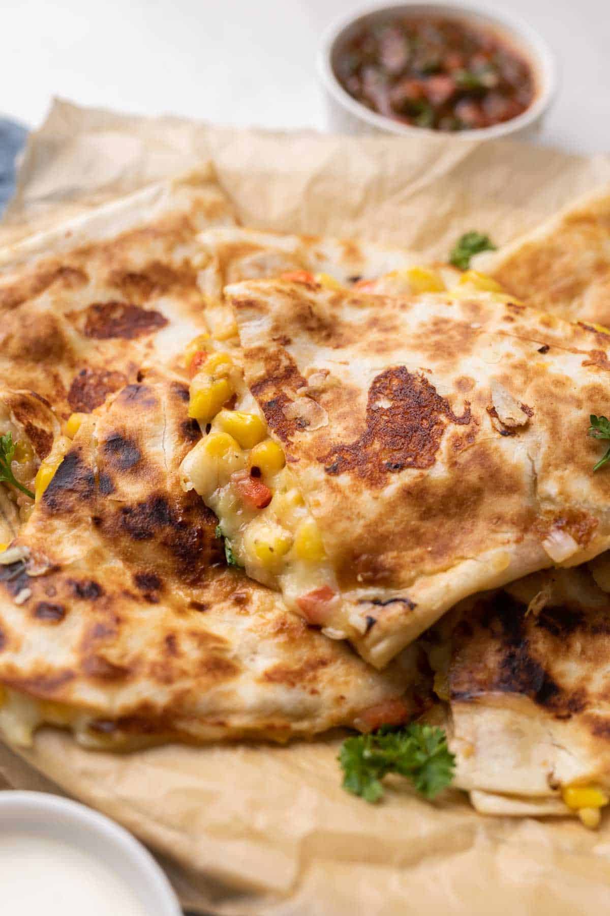 bell pepper corn and cheese quesadilla with crispy bits of cheese with a side of tomato salsa