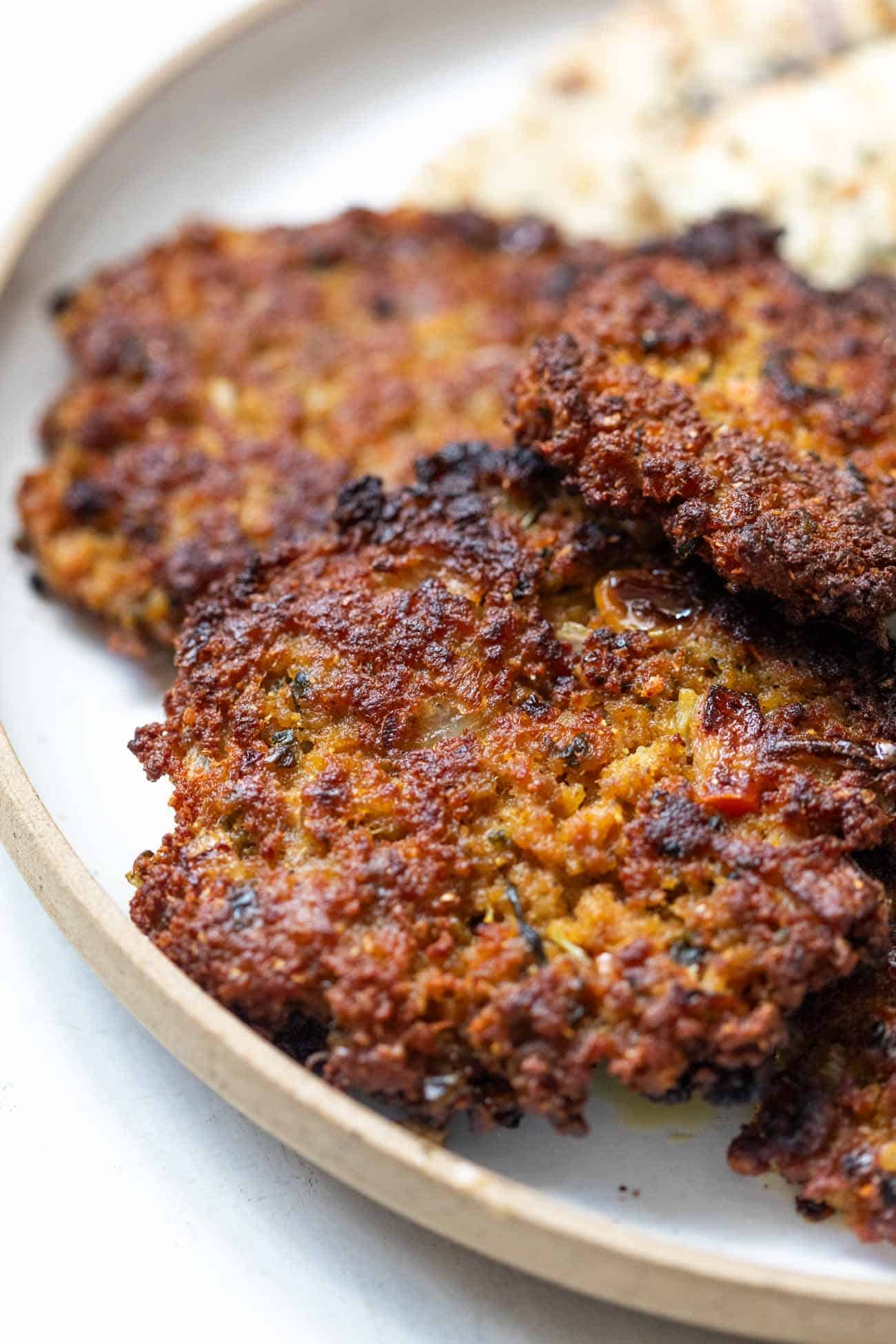 close up shot chapli kebab in a white plate