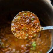 Closeup of a ladleful of Dhaba style mixed dal to show the texture