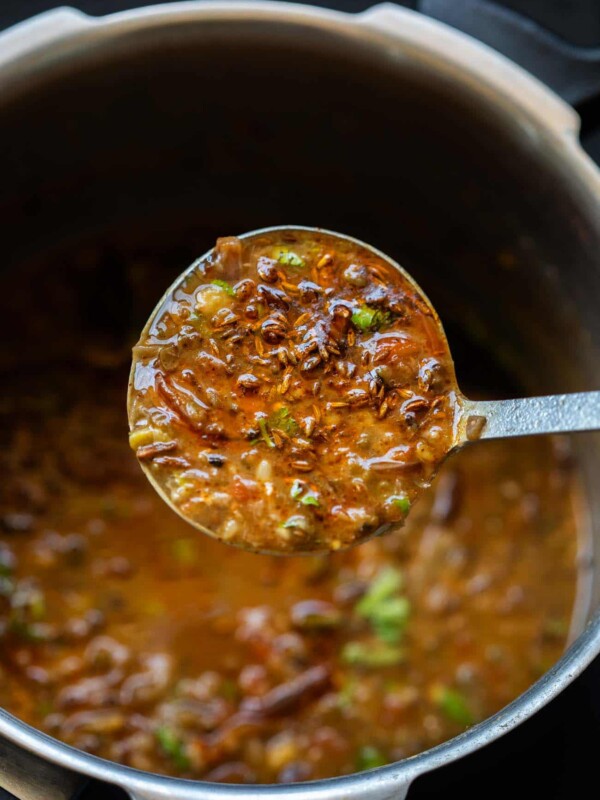 Closeup of a ladleful of Dhaba style mixed dal to show the texture