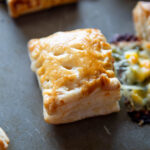 closeup shot of corn spinach puff with the filling oozing out