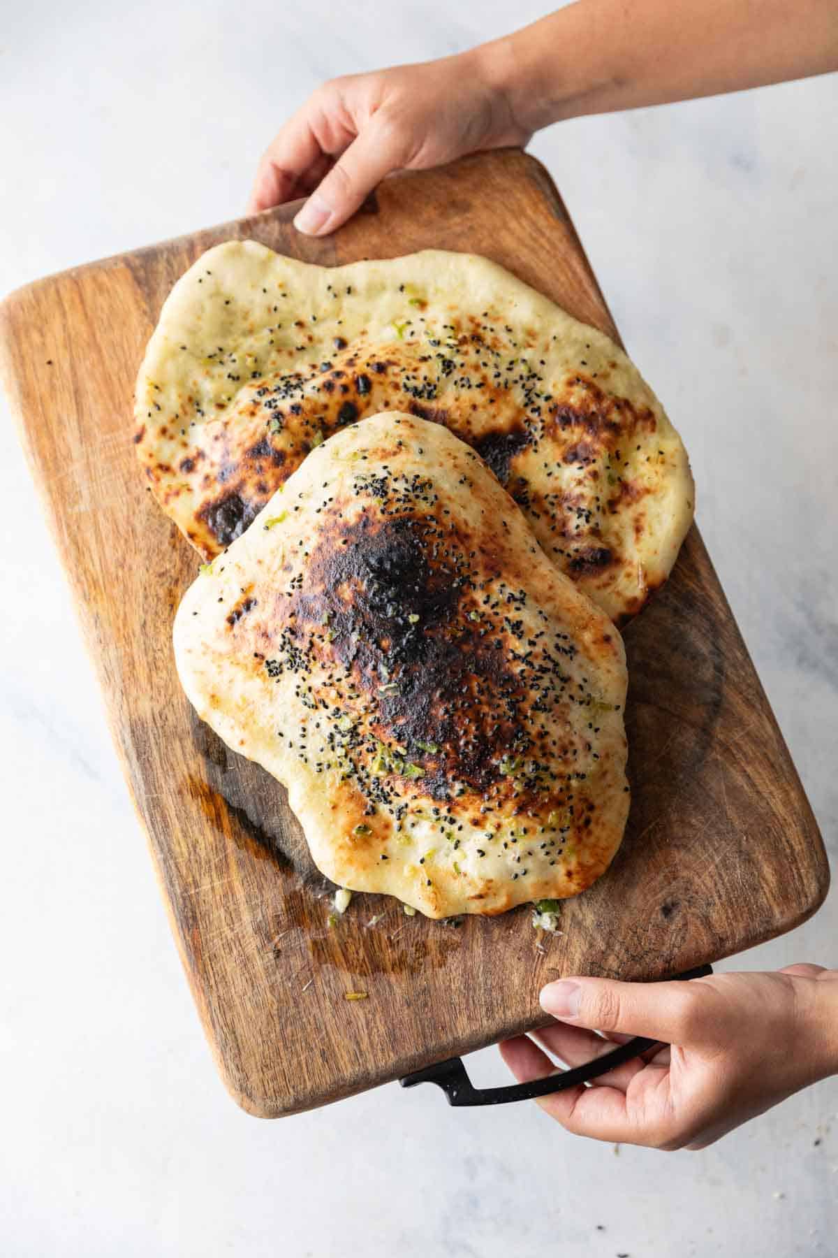 garlic thecha naan on a wooden board