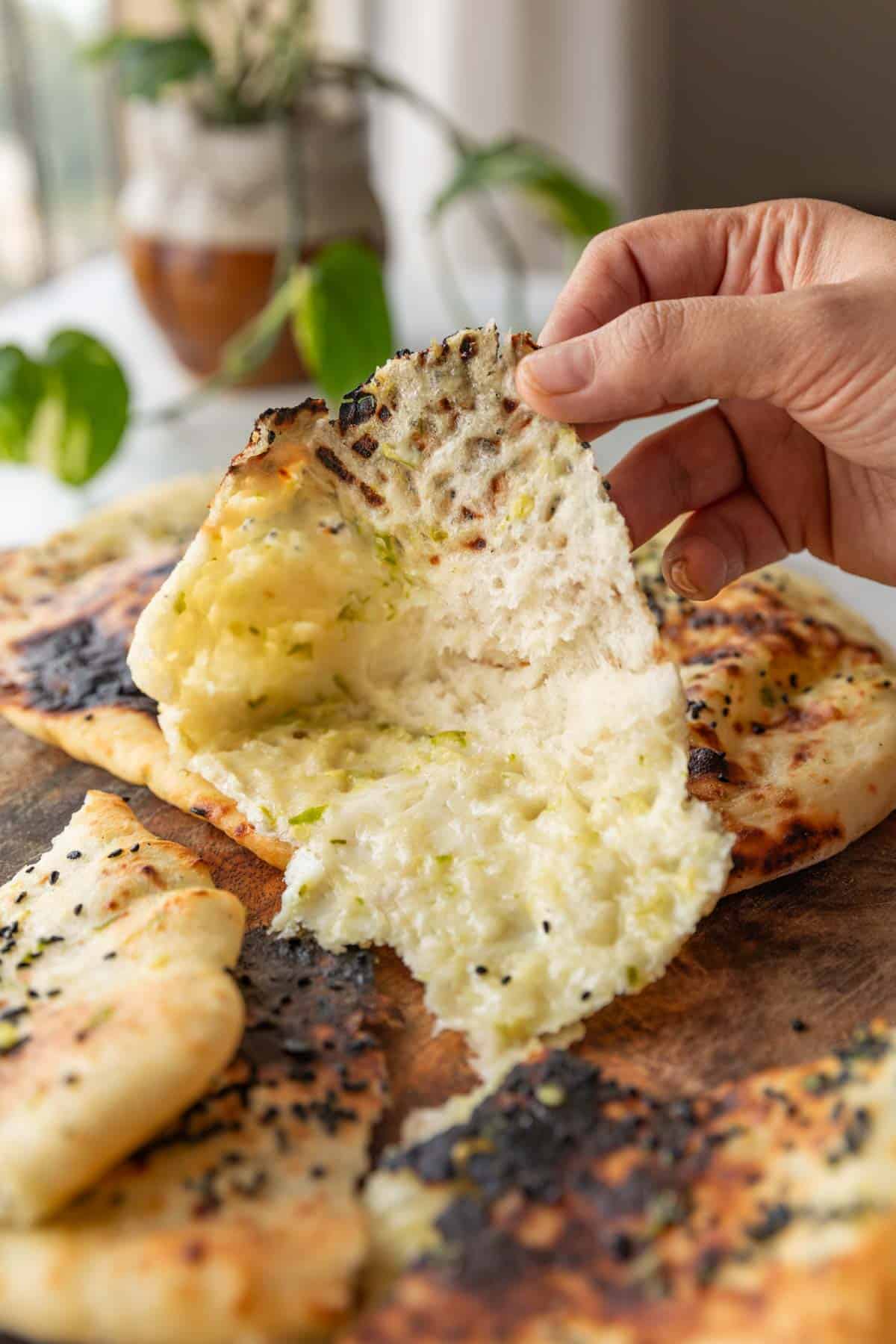 a picture of a cross-section of thecha naan with the stuffing visible