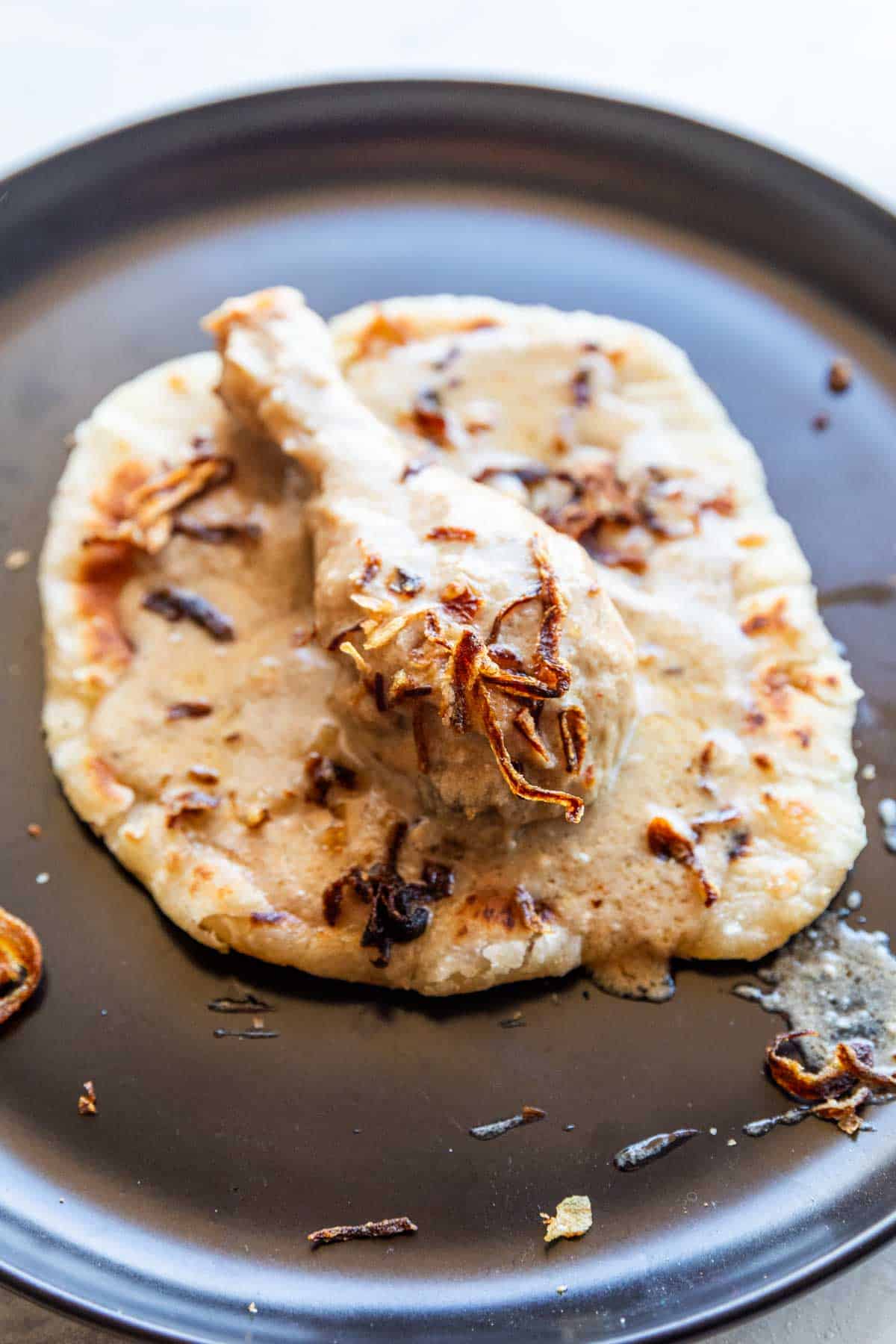 Creamy chicken rezala with served on a black plate