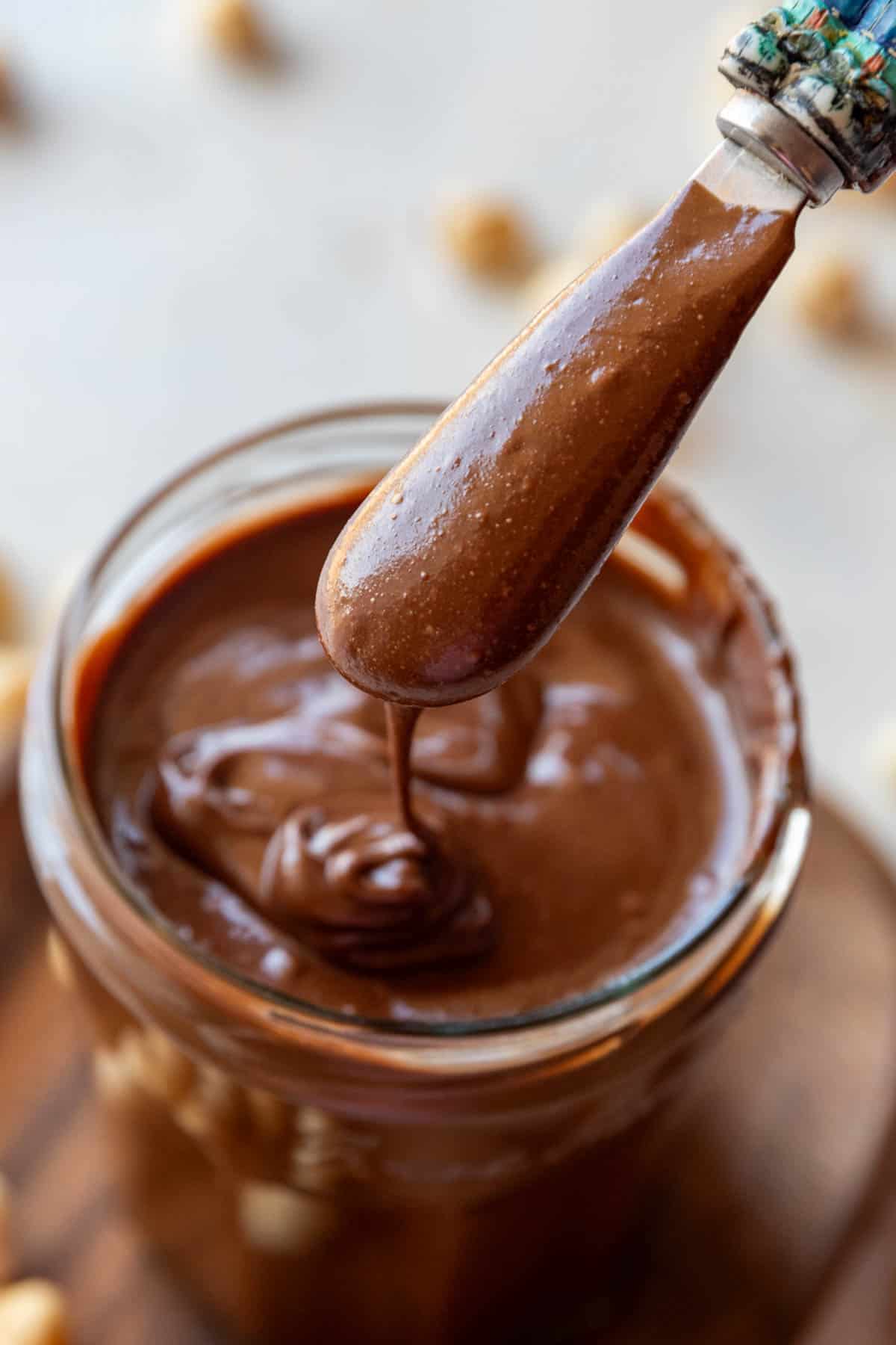Homemade Nutella chocolate spread in a jar with spoon