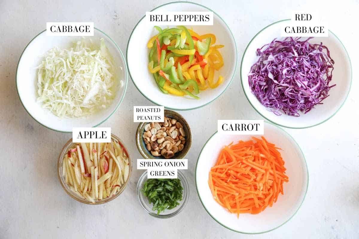 Asian Slaw mix ingredients in bowls with text overlay