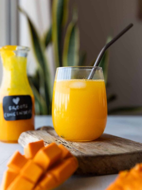 mango juice in a glass jar with straw