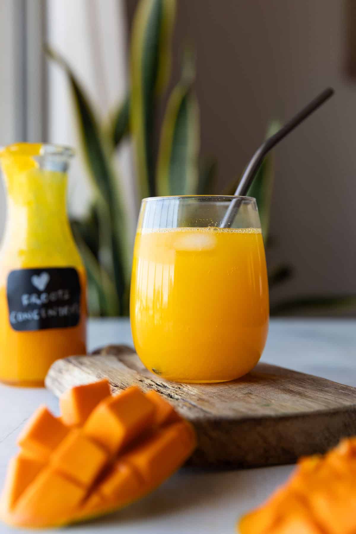 mango juice in a glass jar with straw 