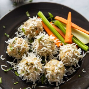 chicken porcupine meatballs served with a salad and a dipping sauce