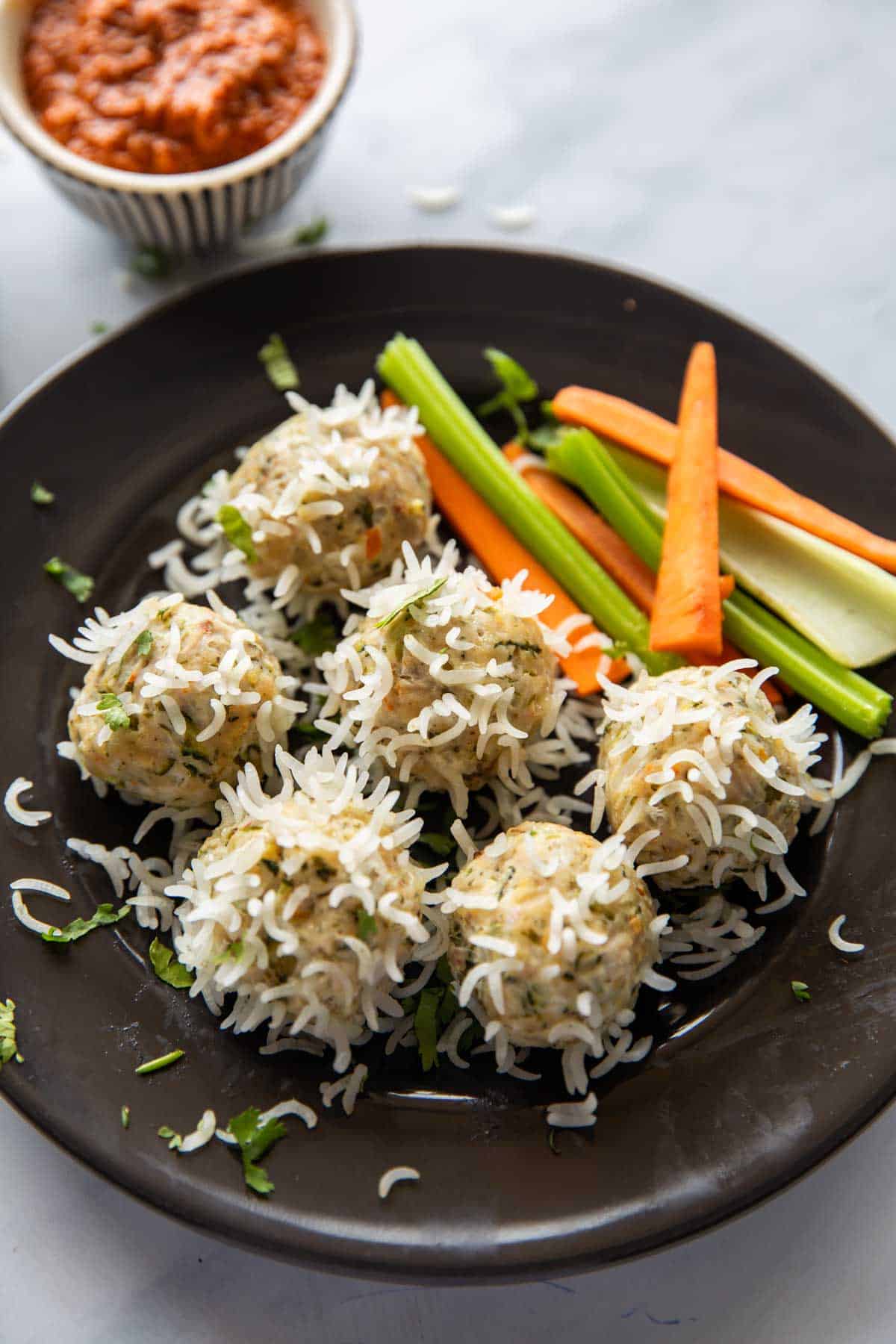 chicken porcupine meatballs served with a salad and a dipping sauce 