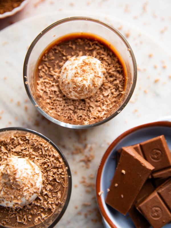 Paneer chocolate pudding garnished with cream and cocoa powder