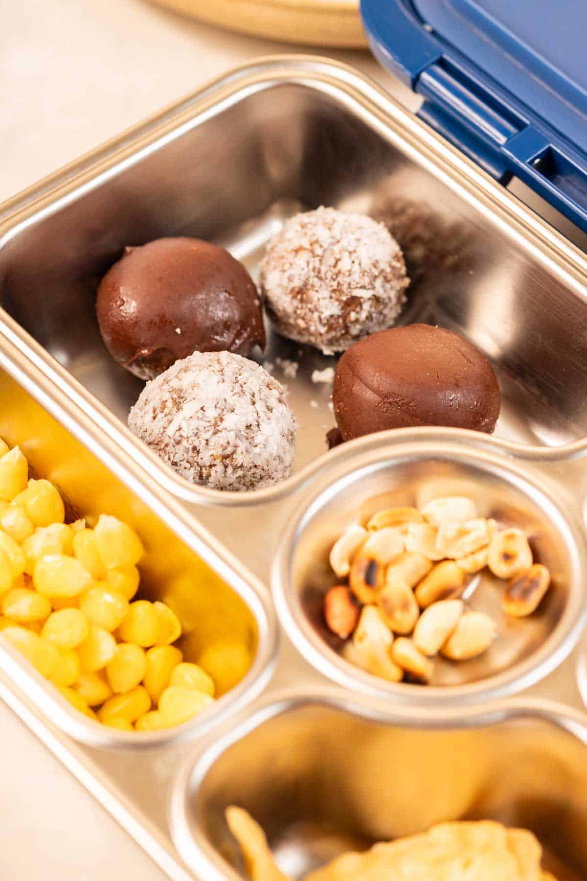 peanut butter oats energy balls with dates in a tiffin box