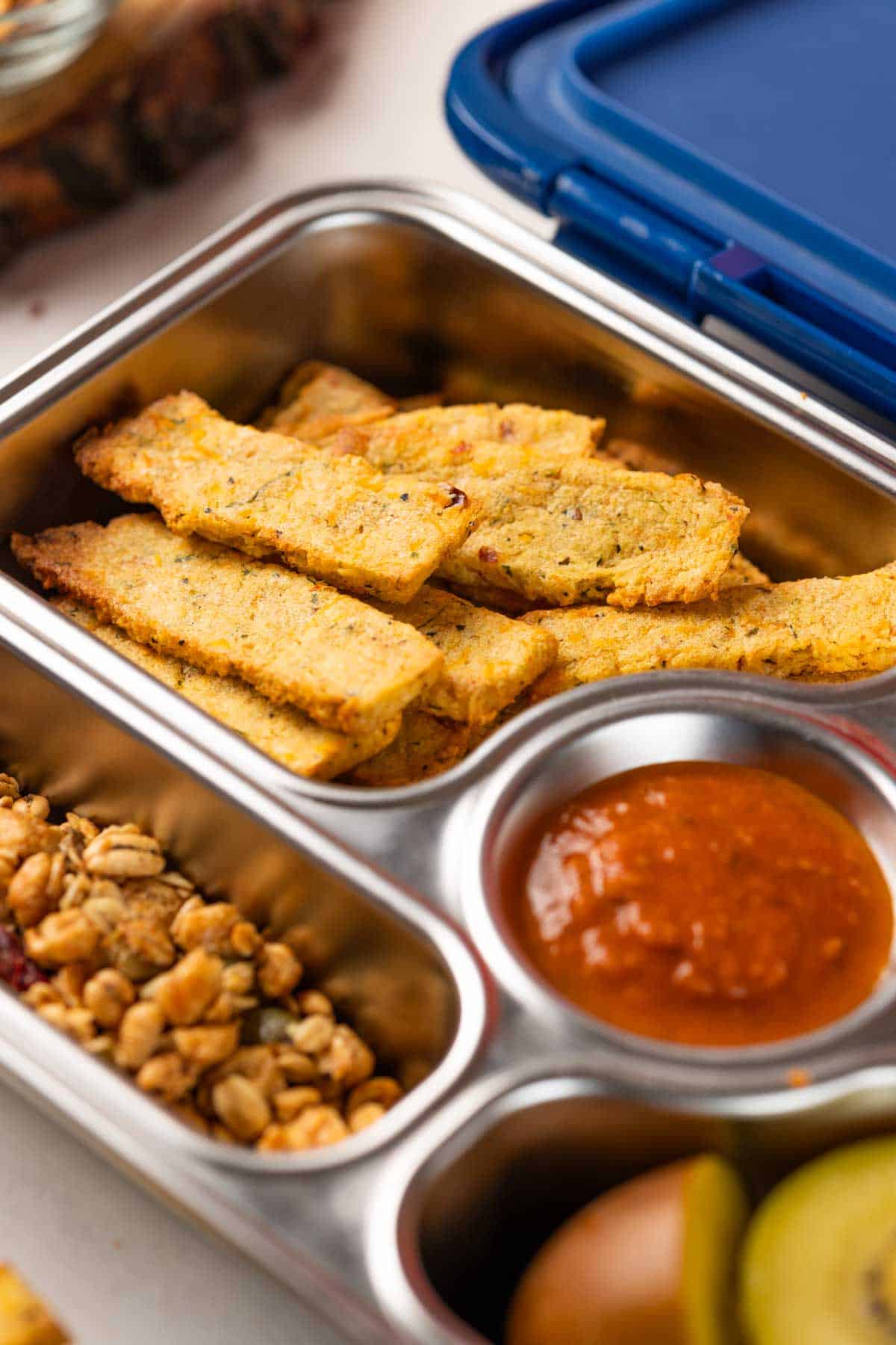 sooji fries with tomato ketchup and farsan mix in a tiffin box