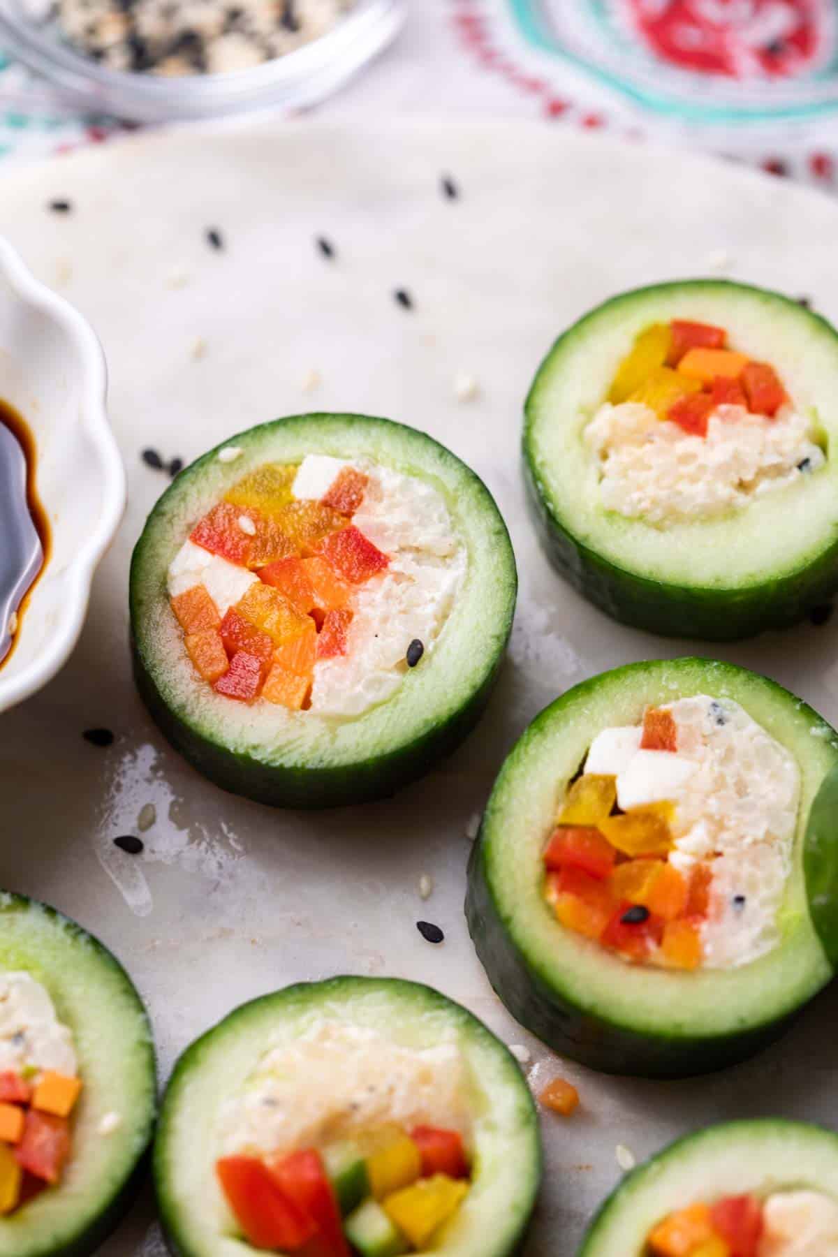 close up of cucumber sushi served with soy sauce