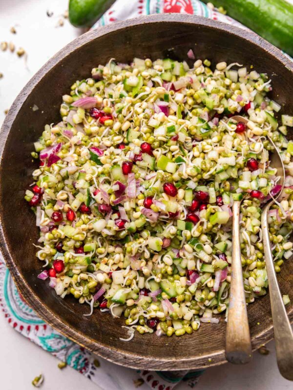 moong sprouts & apple salad in a wooden bowl with spoons
