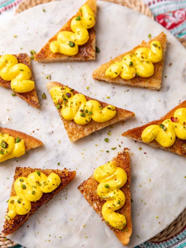 rasmalai sandwich garnished with pistachios and served on a white platter