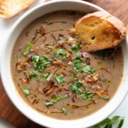 thick & wholesome horse gram soup garnished with birista and coriander, served with bread