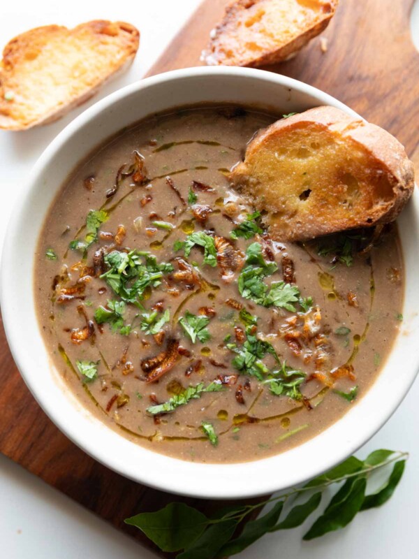 thick & wholesome horse gram soup garnished with birista and coriander, served with bread