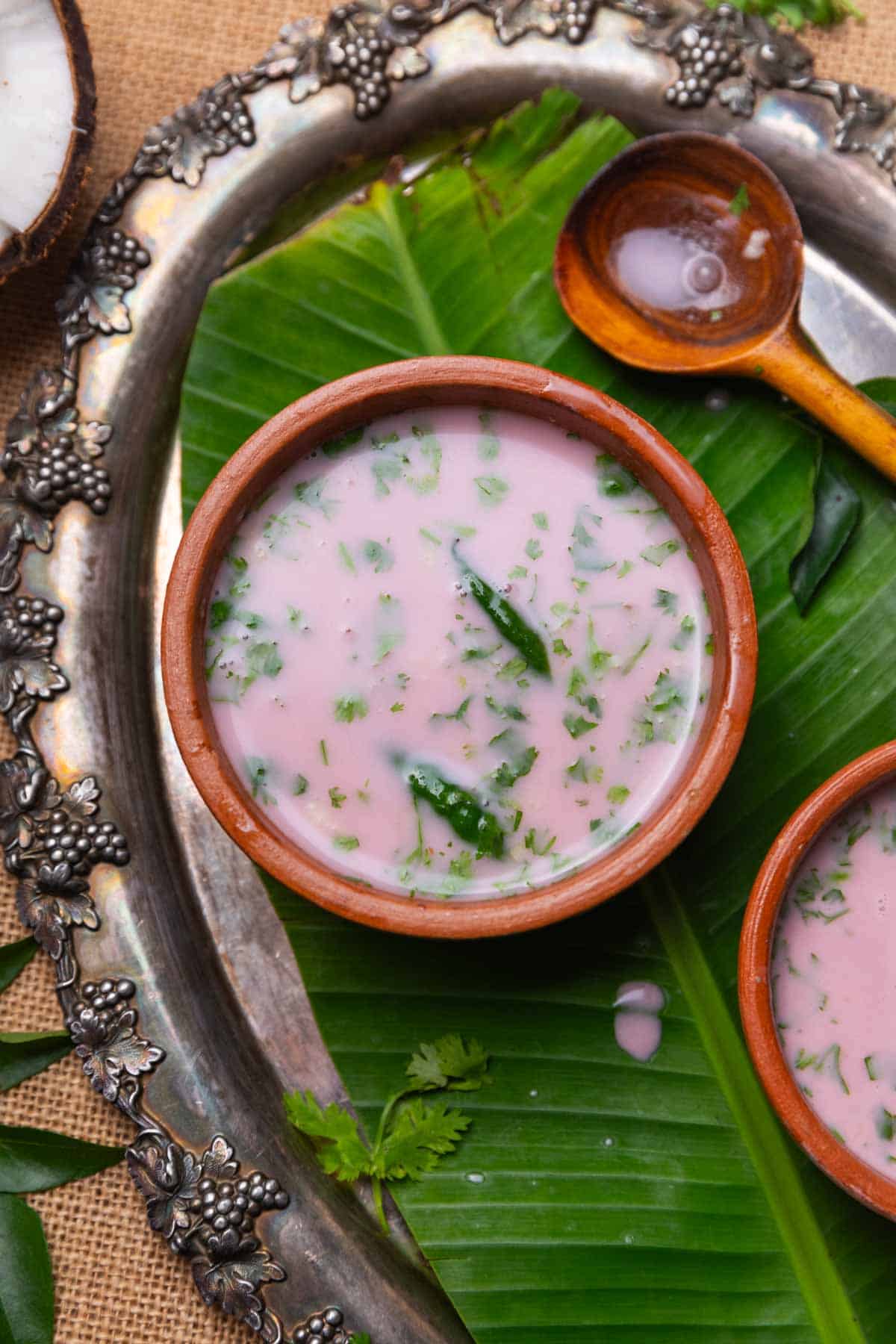 sol kadhi served in small earthen bowls with a spoon